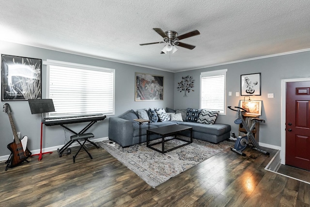 living room with dark wood-type flooring, ceiling fan, crown molding, and a textured ceiling