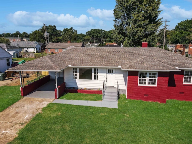 ranch-style home featuring a carport and a front yard