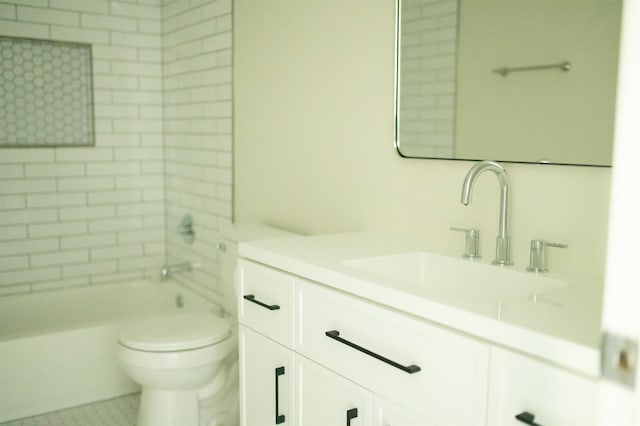 bathroom featuring washtub / shower combination, vanity, and toilet