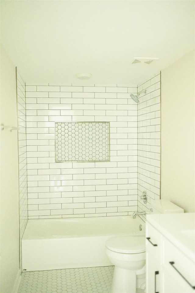 bathroom featuring  shower combination, vanity, toilet, and tile patterned floors