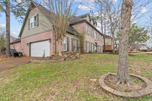 exterior space featuring a front yard, brick siding, driveway, and an attached garage