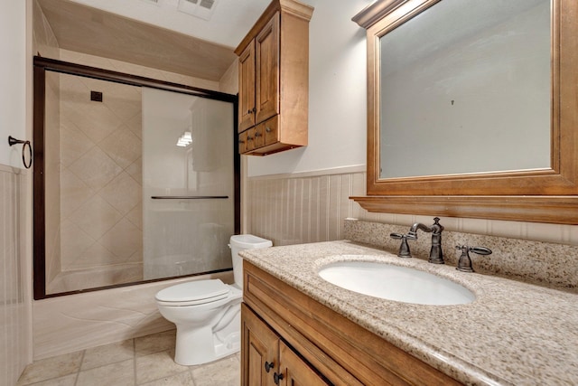 full bathroom featuring tile patterned floors, enclosed tub / shower combo, vanity, and toilet