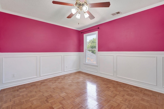 empty room featuring a textured ceiling, ceiling fan, and light parquet floors