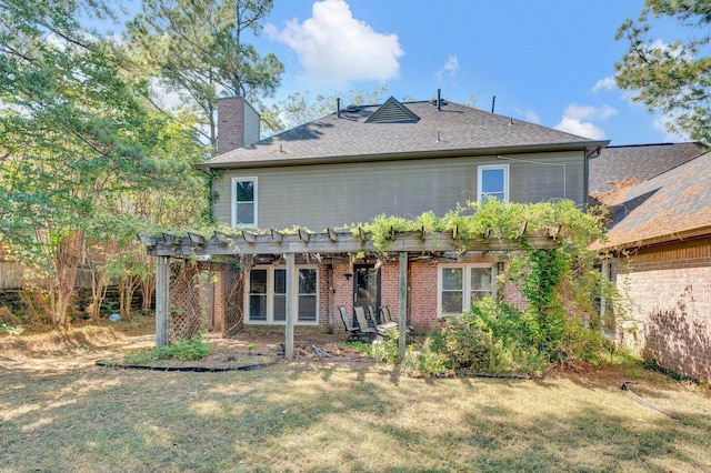 rear view of house with a lawn and a pergola