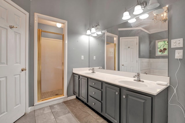 bathroom featuring tile patterned flooring, a shower with door, and vanity