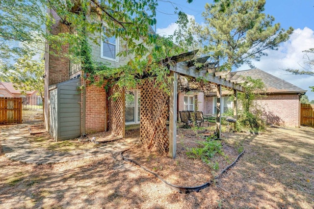 back of property with a pergola