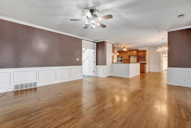 unfurnished living room with light hardwood / wood-style floors, ceiling fan with notable chandelier, and crown molding