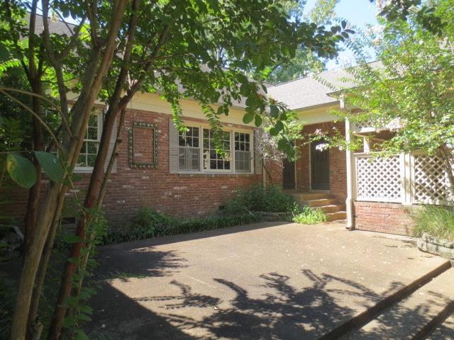 exterior space featuring brick siding