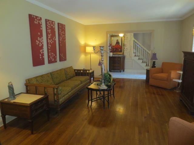 living room featuring stairway, wood finished floors, and ornamental molding