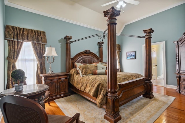 bedroom featuring ceiling fan, crown molding, light wood-type flooring, and lofted ceiling