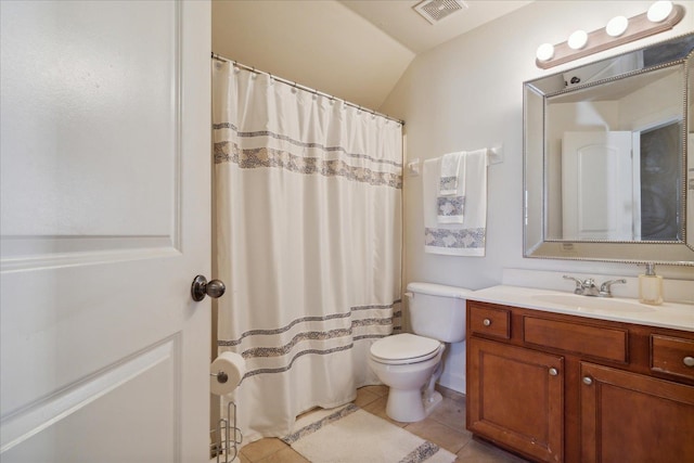 bathroom with tile patterned floors, vaulted ceiling, vanity, and toilet