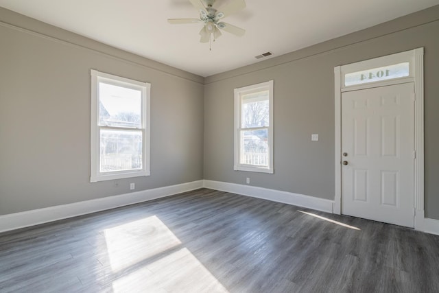 entryway featuring ceiling fan, visible vents, baseboards, and dark wood finished floors