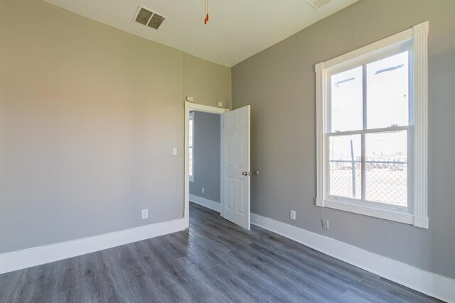 full bathroom with wood-type flooring, plenty of natural light, toilet, and vanity