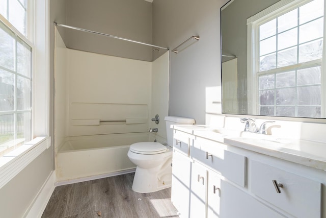 full bathroom featuring shower / bathtub combination, toilet, vanity, and wood finished floors