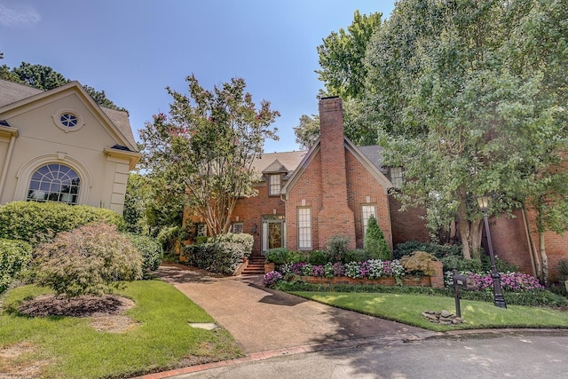 view of front of property with a front yard and brick siding