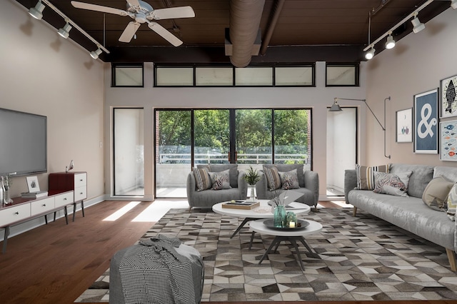 living room featuring a high ceiling, track lighting, wood-type flooring, ceiling fan, and wooden ceiling