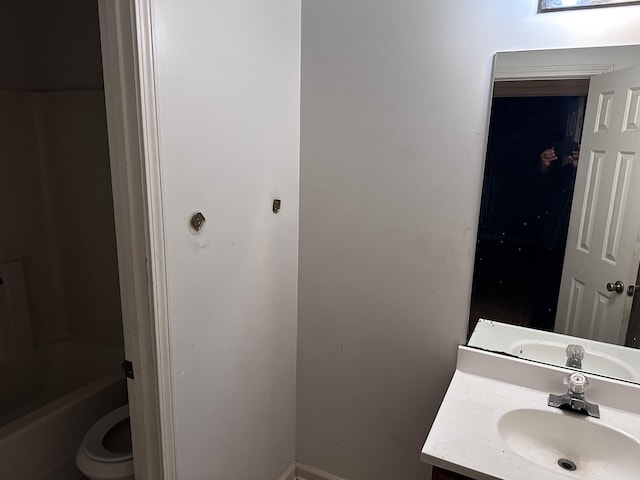 795 Williams Ave, Memphis, TN 38126 - bathroom featuring vanity, toilet, tub / shower combination, and baseboards