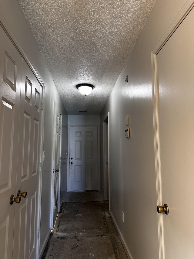 795 Williams Ave, Memphis, TN 38126 - hallway featuring a textured ceiling and baseboards
