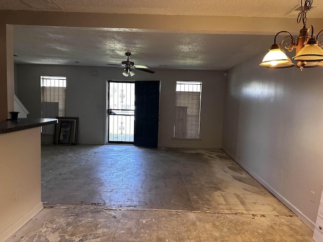795 Williams Ave, Memphis, TN 38126 - unfurnished living room featuring plenty of natural light, a textured ceiling, baseboards, and ceiling fan