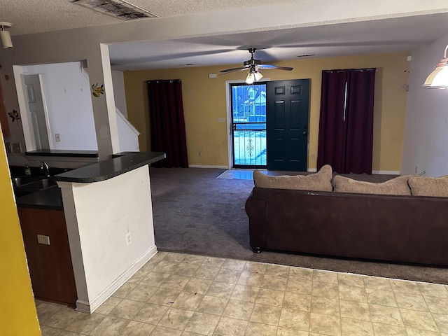 795 Williams Ave, Memphis, TN 38126 - living room featuring ceiling fan, a textured ceiling, light carpet, and baseboards