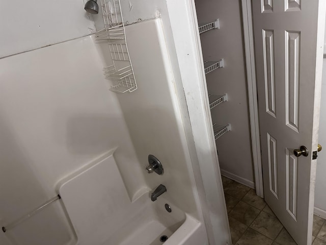 795 Williams Ave, Memphis, TN 38126 - bathroom with bathing tub / shower combination, baseboards, and tile patterned floors