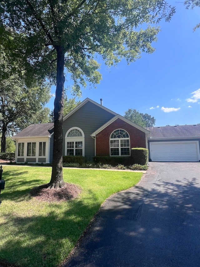 single story home with a front yard and a garage