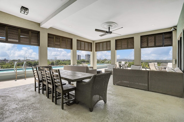 sunroom / solarium featuring a wealth of natural light and ceiling fan