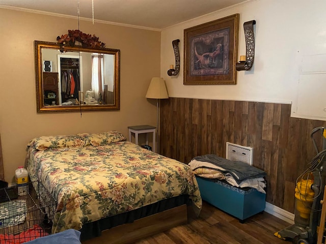 bedroom with crown molding and dark wood-type flooring