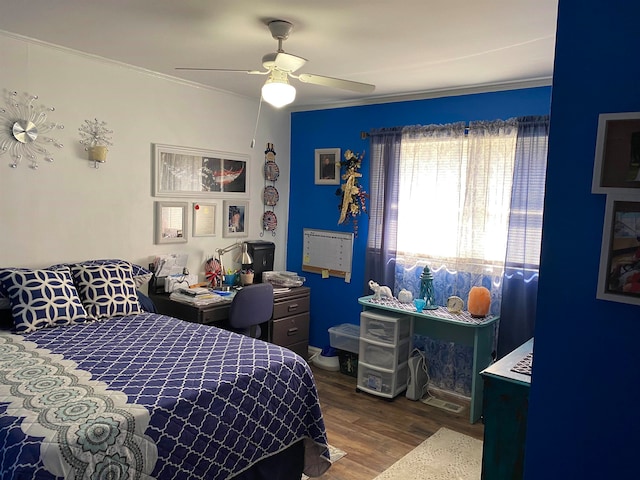 bedroom with ceiling fan, dark wood-type flooring, and ornamental molding