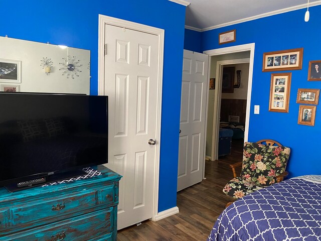 bedroom with ornamental molding and dark hardwood / wood-style flooring