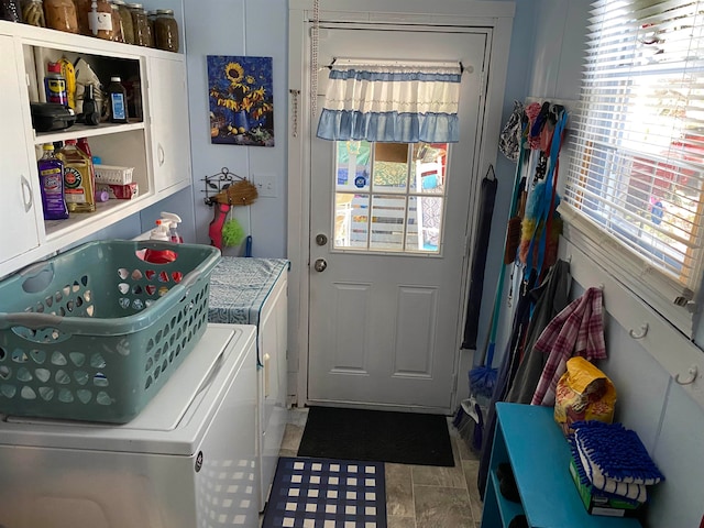 doorway featuring tile patterned flooring and washing machine and dryer