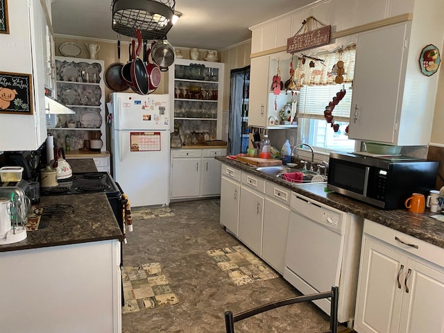 kitchen with dark tile patterned floors, sink, crown molding, white cabinets, and white appliances