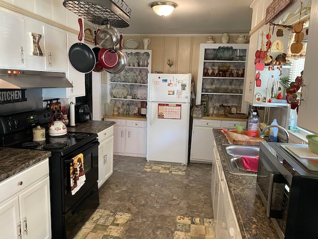 kitchen featuring dark tile patterned floors, white cabinetry, black / electric stove, dark stone countertops, and white refrigerator