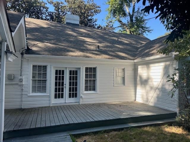 rear view of property with a wooden deck