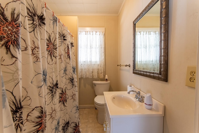 bathroom featuring plenty of natural light, vanity, toilet, and tile patterned floors