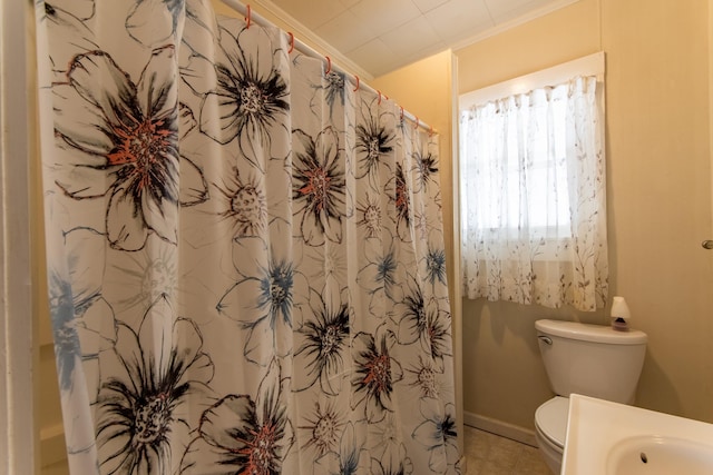 bathroom featuring toilet, a shower with curtain, and tile patterned flooring