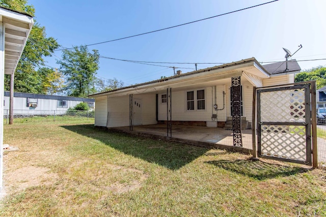 rear view of property with a yard