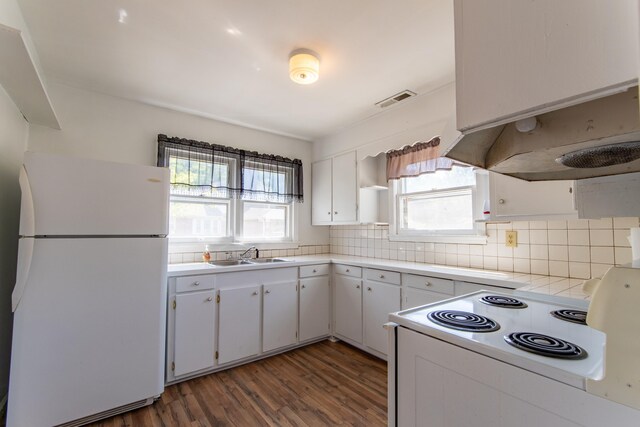 kitchen featuring white appliances, dark hardwood / wood-style flooring, sink, decorative backsplash, and white cabinets