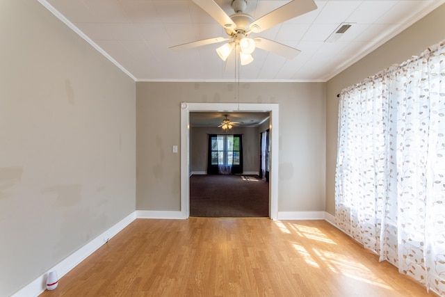 spare room featuring ceiling fan, light hardwood / wood-style floors, and ornamental molding