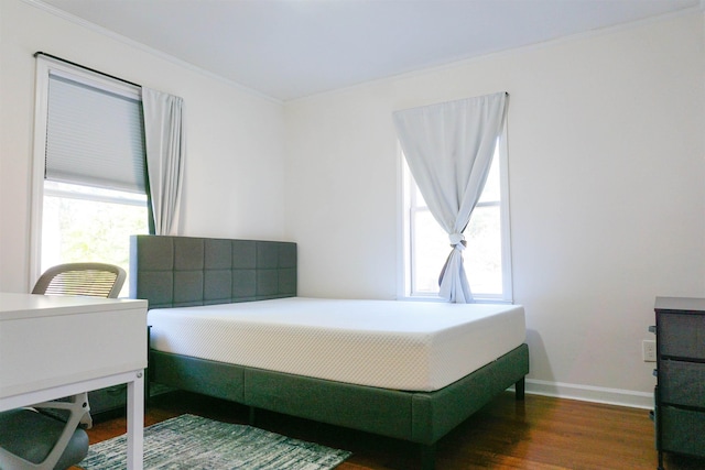 bedroom with baseboards and dark wood-style flooring