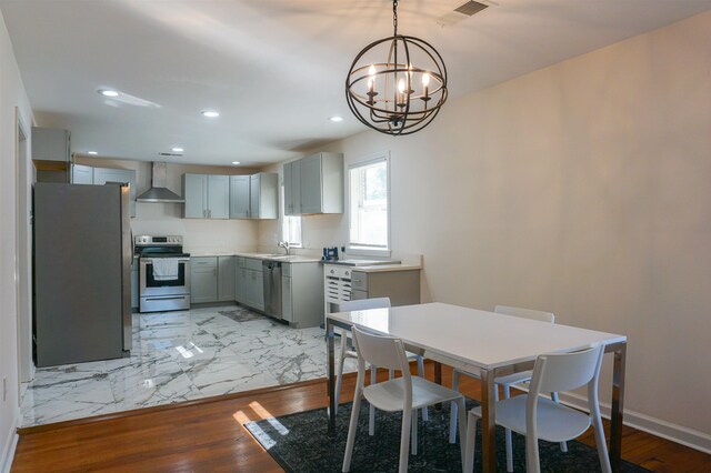 dining area featuring a notable chandelier and light hardwood / wood-style floors