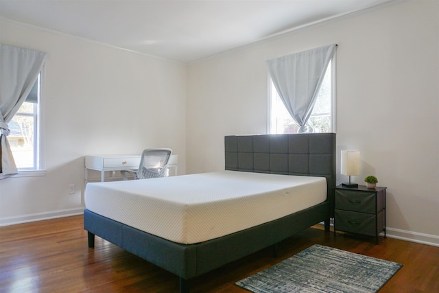 bedroom with dark wood-style flooring and baseboards