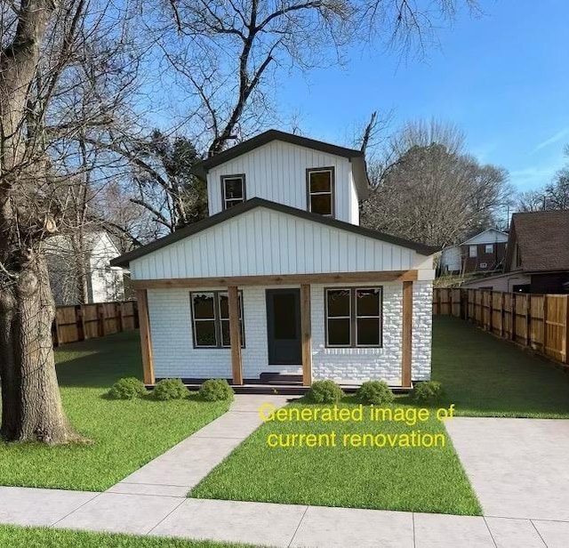 311 W Court Ave, Selmer, TN 38375 - view of front of property featuring a front yard, fence, and brick siding