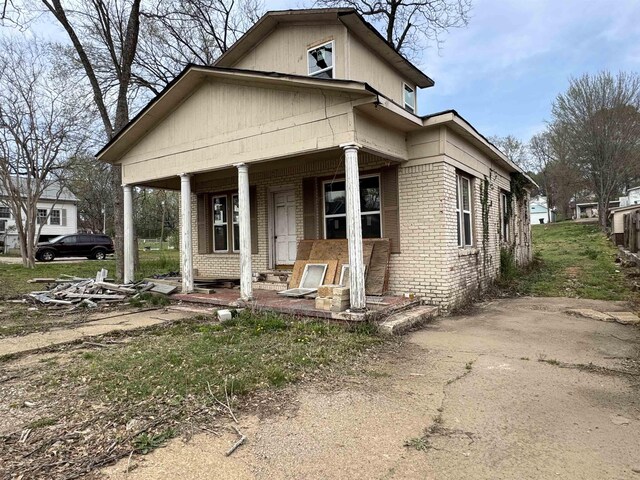 311 W Court Ave, Selmer, TN 38375 - view of front of house featuring brick siding and covered porch