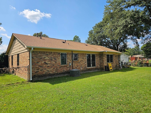 back of house featuring cooling unit and a yard