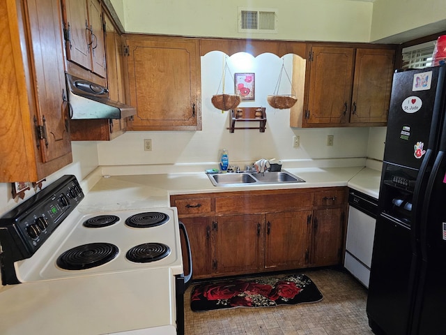 kitchen featuring tile patterned flooring, white appliances, and sink