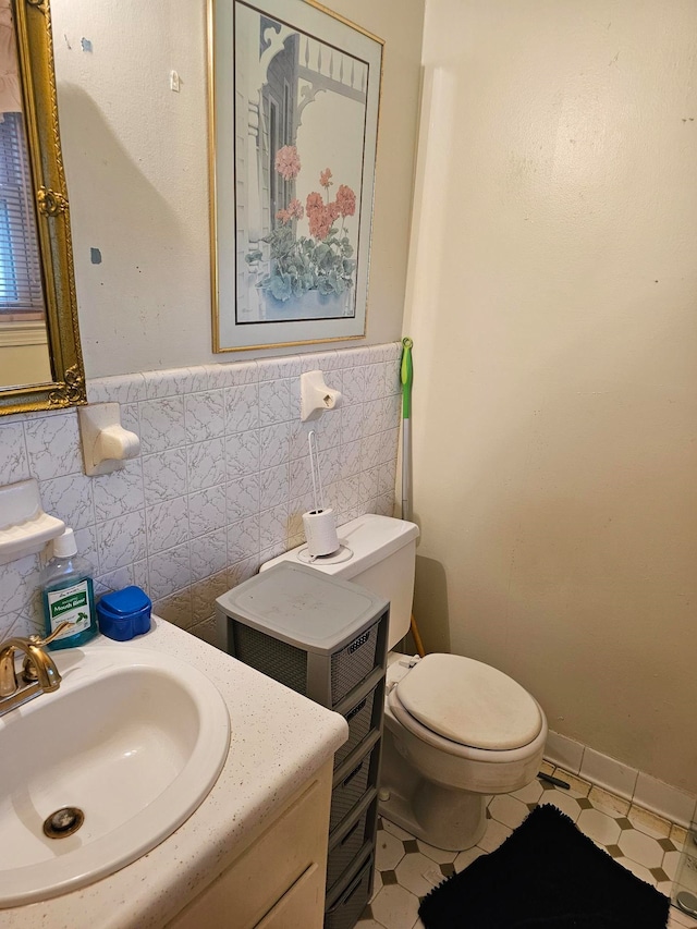 bathroom featuring tile patterned floors, toilet, tile walls, tasteful backsplash, and vanity