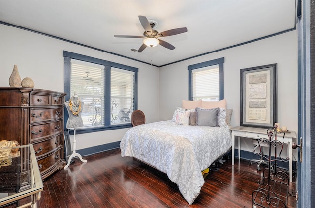 bedroom with a ceiling fan, crown molding, baseboards, and hardwood / wood-style floors