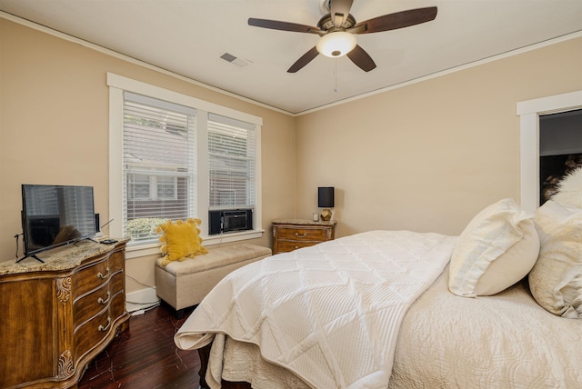 bedroom featuring dark wood-style flooring, crown molding, visible vents, ceiling fan, and cooling unit