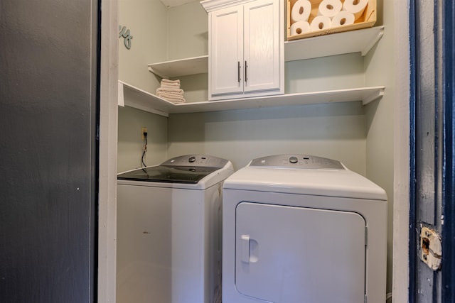 clothes washing area with cabinet space and washer and clothes dryer